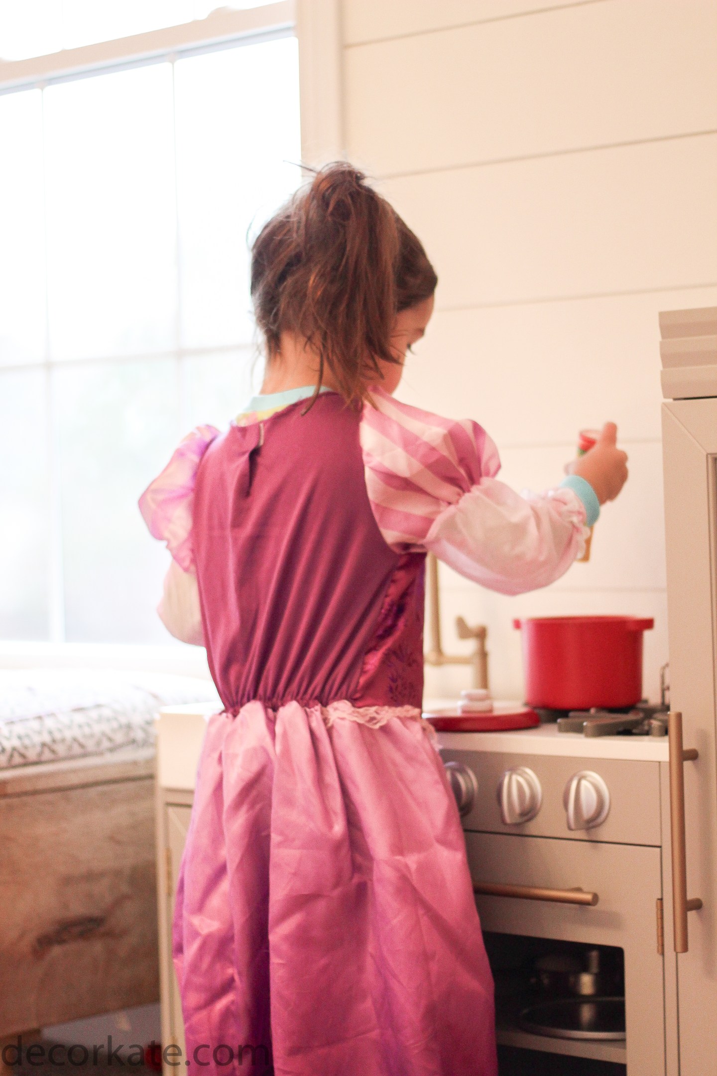 girl playing in kitchen